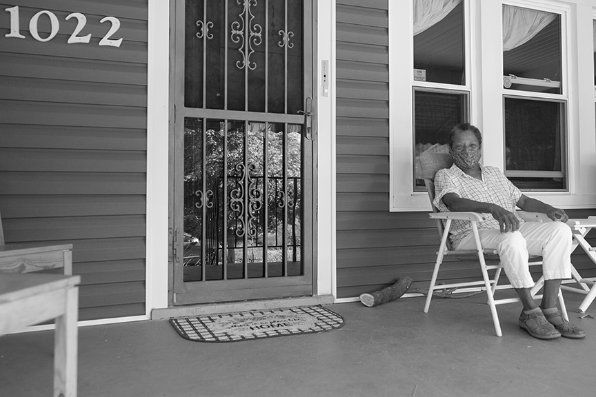 Alice, pictured wearing a mask, is relaxing on a chair on her front porch. 