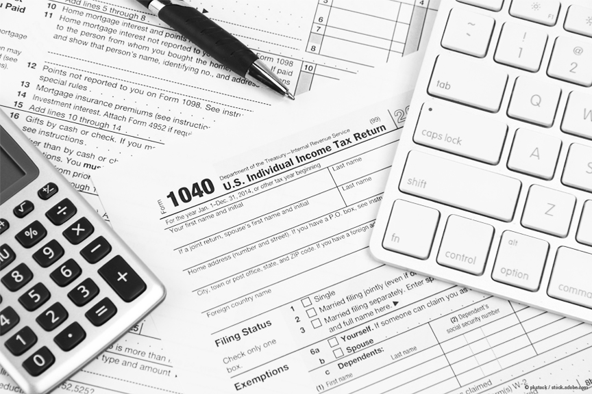 Tax paperwork, a calculator and a computer keyboard