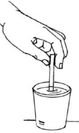 dipping the strip into the cup