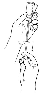 Pulling the medicine out of the vial with a syringe