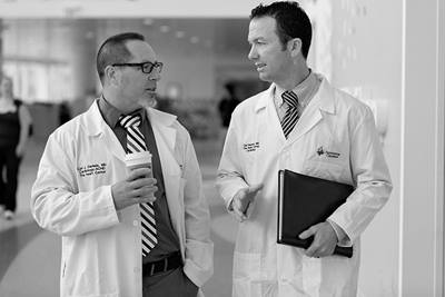 Dr. Daniels and colleague in hallway