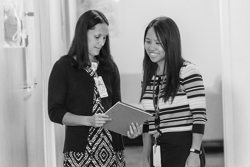 Two medical professionals talking in a hallway