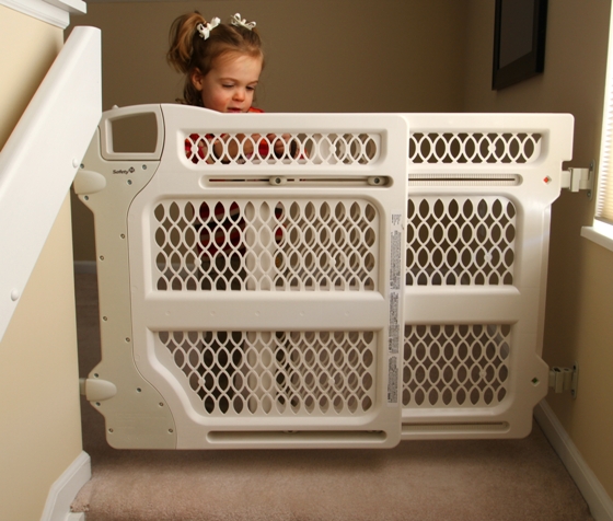 Small child behind baby gate