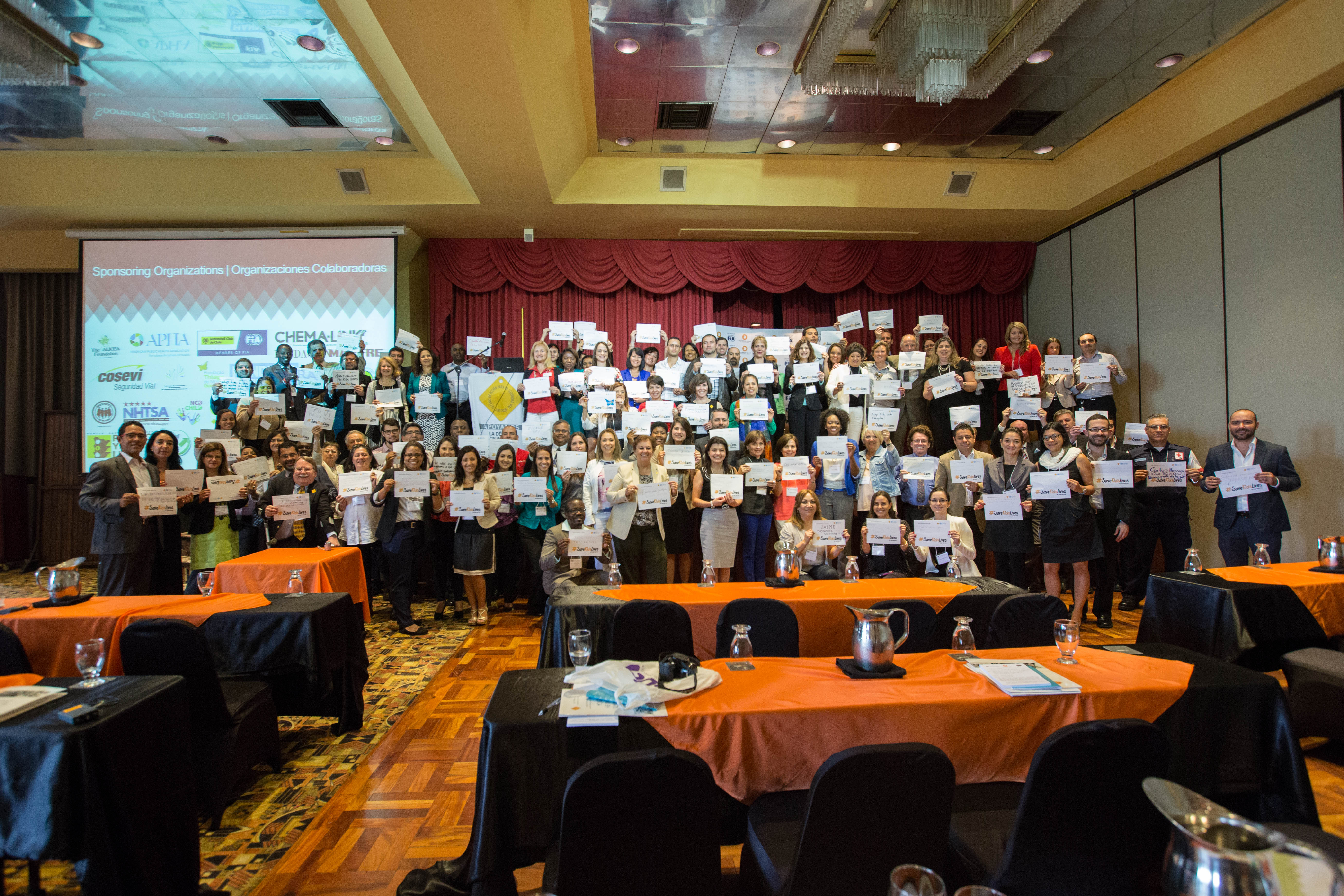 conference participants holding up signs