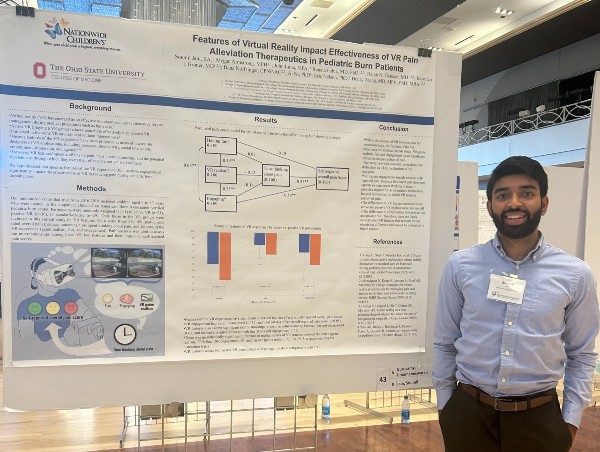 Nationwide Children's Research Student in front of a first place winning poster he created